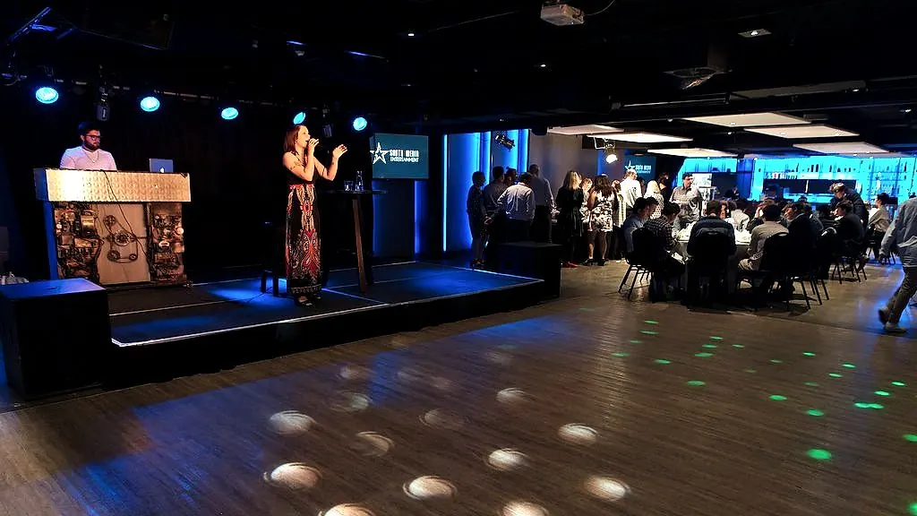 Corporate function with live singer, DJ booth and stage lighting