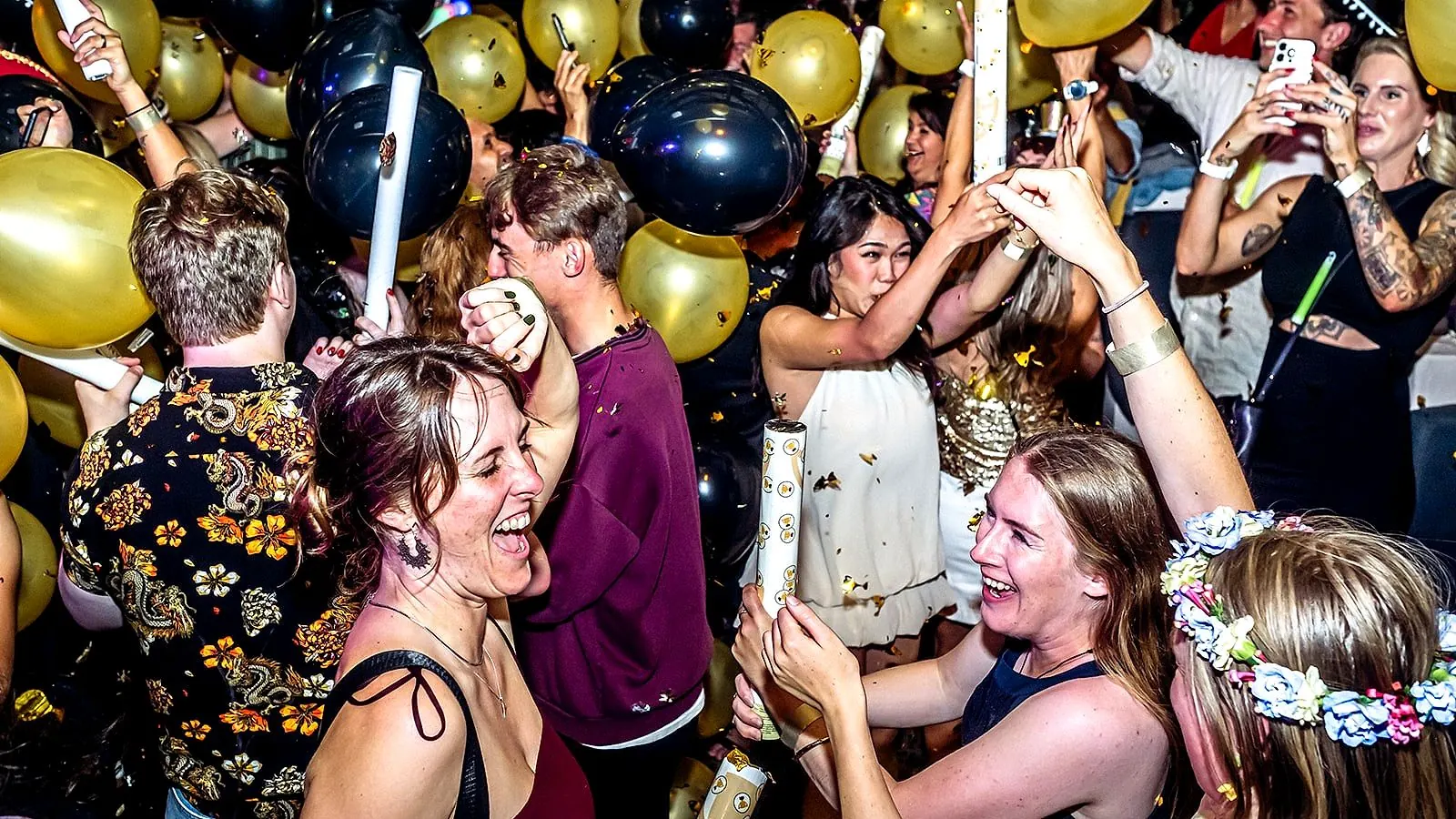 Packed dance floor with confetti at a South Media party